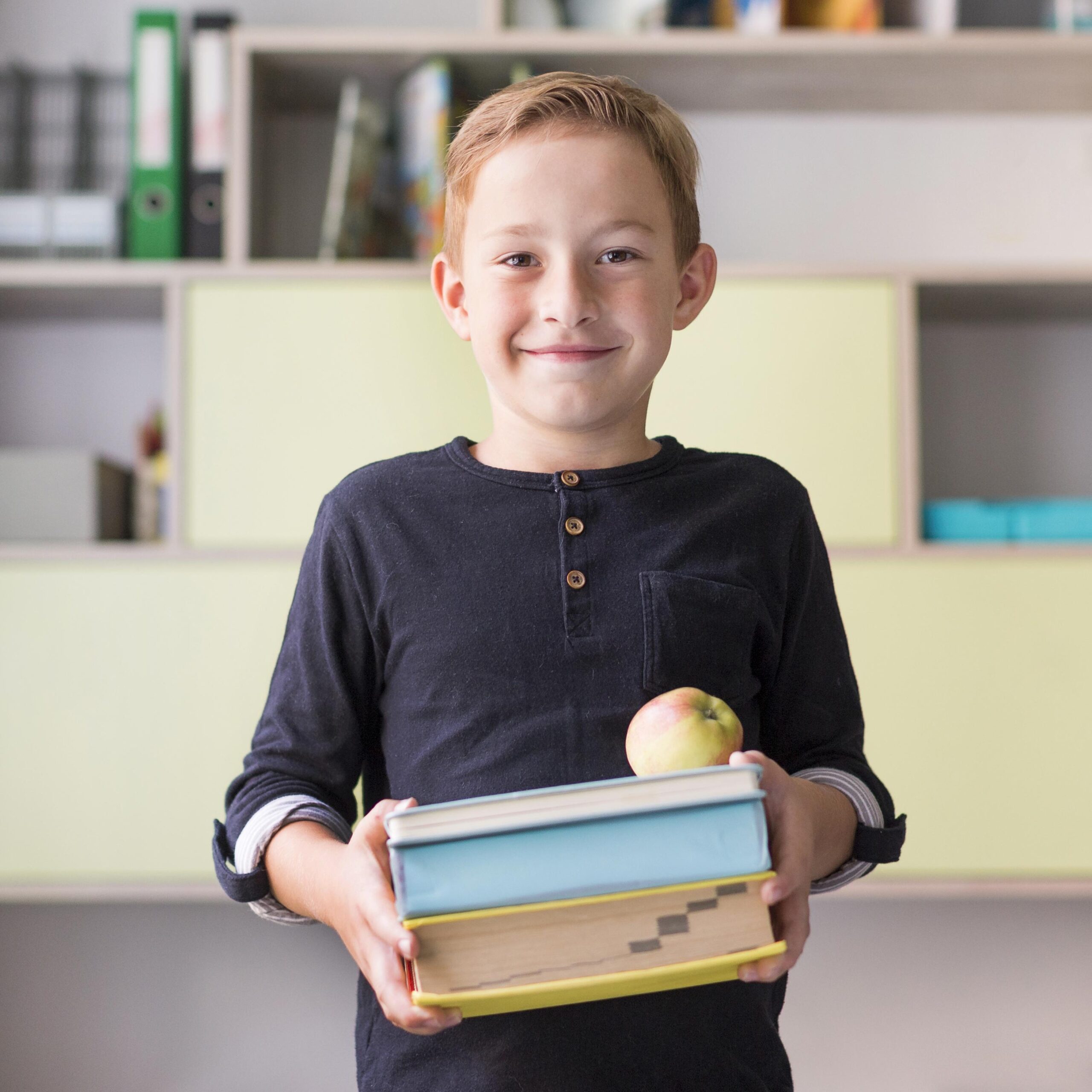 smiley-kid-holding-bunch-books